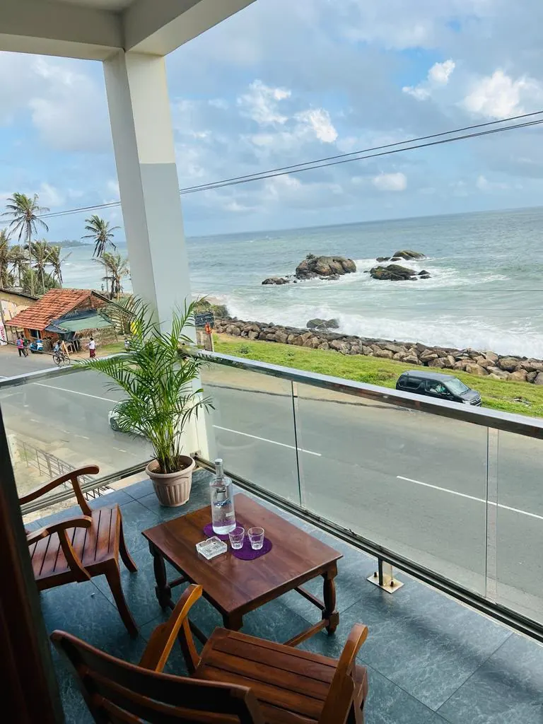 Balcony looking across the road to the rocky shoreline