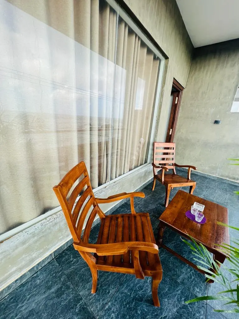 Close view of polished wooden balcony chairs and table