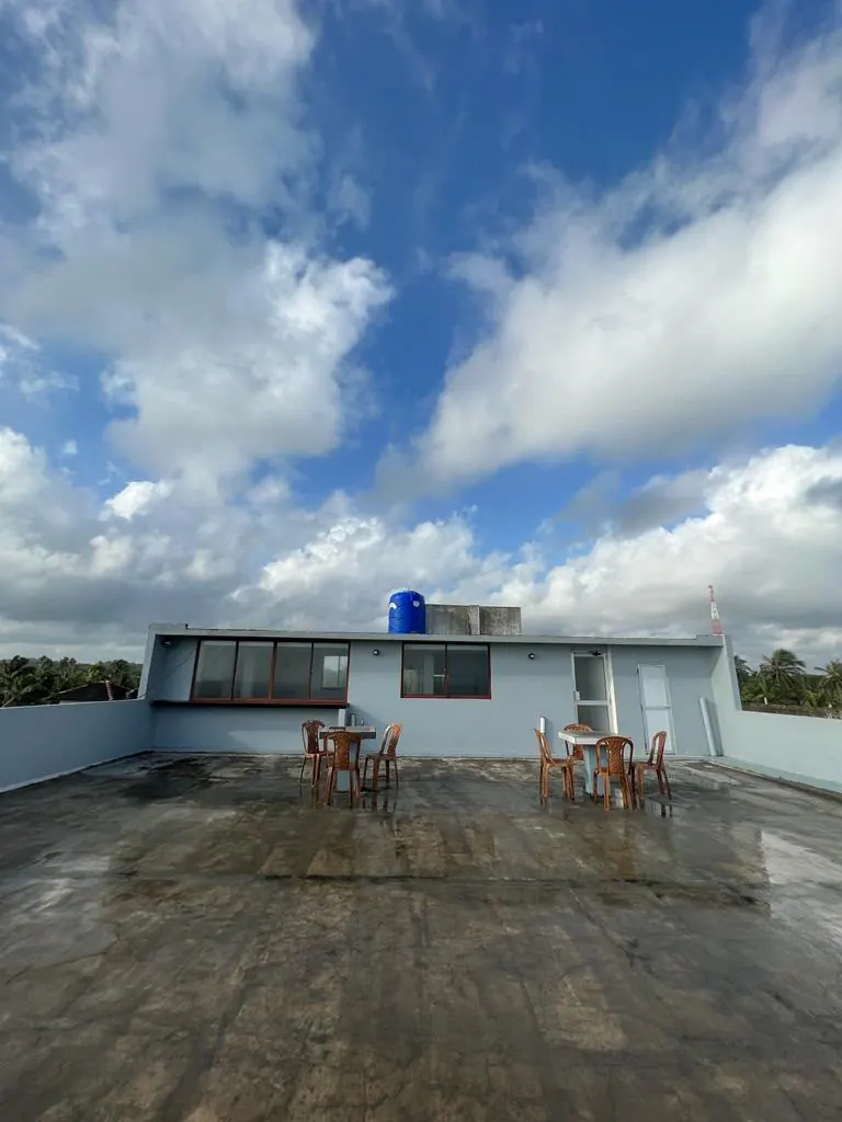 Large rooftop terrace with tables and chairs