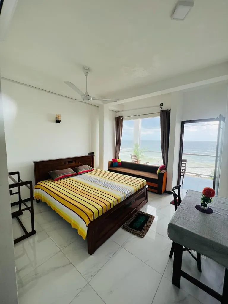 Bright sea view room with a king size bed and wide window