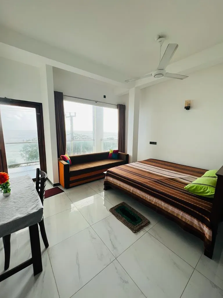 Sea view double room with a sofa and broad windows