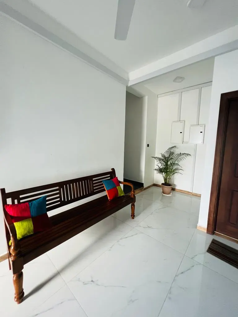 Indoor wooden bench with colourful cushions