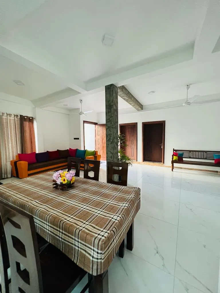 Large shared dining table beside the guest lounge